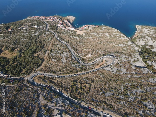 Aerial view of Prizna, Trajekt Prizna-Zigljen to reach the island of Pag. Drone view of queue to catch ferry for Pag. Small town with turquoise water on the hill of Croatia, in Dalmatia. photo