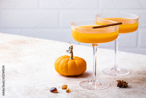 Halloween, Thanksgiving or fall cocktail pumpkin martini, homemade festive seasonal drink pumpkintini with cinnamon photo