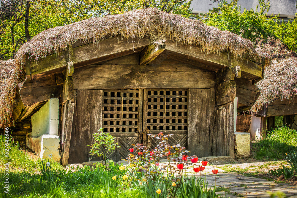 Old wooden house or windmill in autumn light
