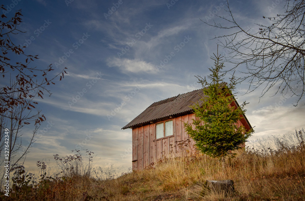 Old wooden house or windmill in autumn light
Old wooden house or windmill in autumn light