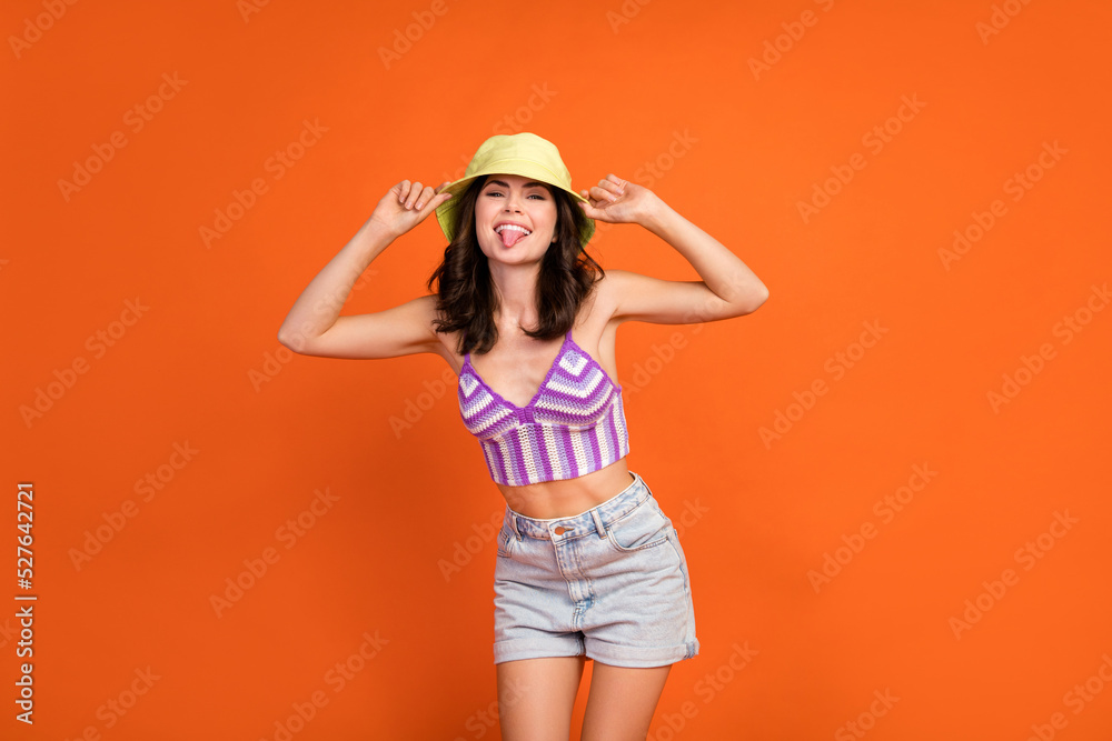 Photo of shiny adorable woman dressed violet bra showing tongue having fun isolated orange color background Photo of shiny adorable woman dressed violet bra showing tongue having fun isolated orange color background