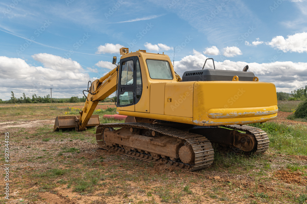 Excavator moving dirt and sand at a construction site