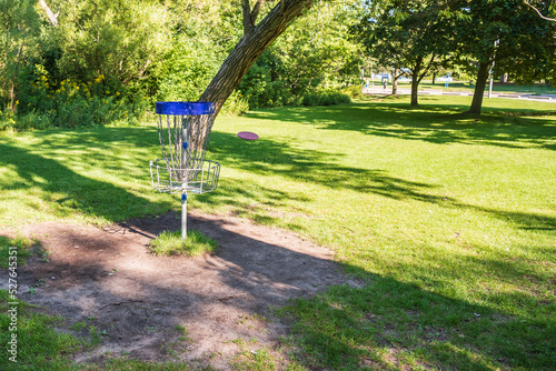 Disc golf, a flying disc sport played using rules like golf, here a disc arrives at a "hole" on course in Ashbridges Bay Park in Toronto’s Beachesin late August.