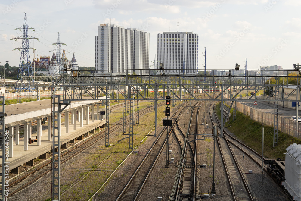 Empty railway tracks of Vostochny station in Moscow. Empty platform. Izmailovsky Kremlin and hotels in the background.