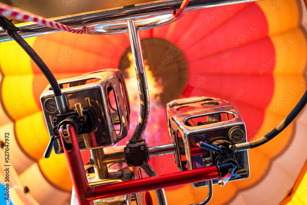 Naklejka premium Inside of a colorful hot air balloon as it is inflated for flight, burning burner