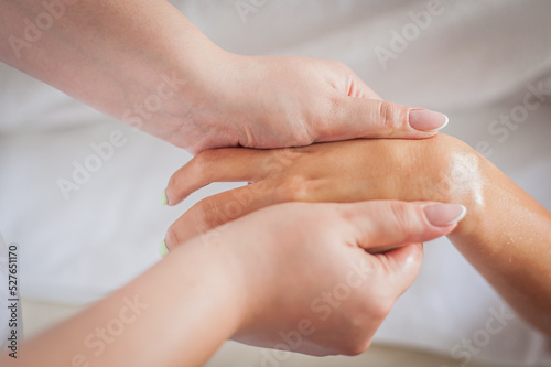 Woman at a health spa having a hand massage and acupressure