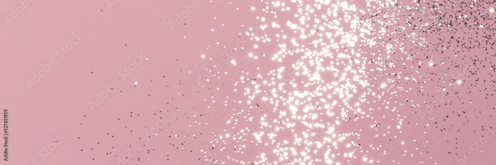 Sparkling silver glitter on pink background banner texture. Abstract holiday blurred lights header. Wide screen wallpaper. Panoramic web banner with copy space for design Sparkling silver glitter on pink background banner texture. Abstract holiday blurred lights header. Wide screen wallpaper. Panoramic web banner with copy space for design