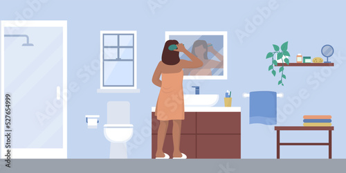 Woman brushing hair in the bathroom