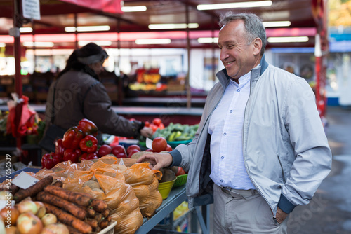Middle aged man buying vegetables