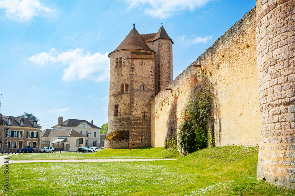 Walls and towers of Blandy-les-Tours castle from the village