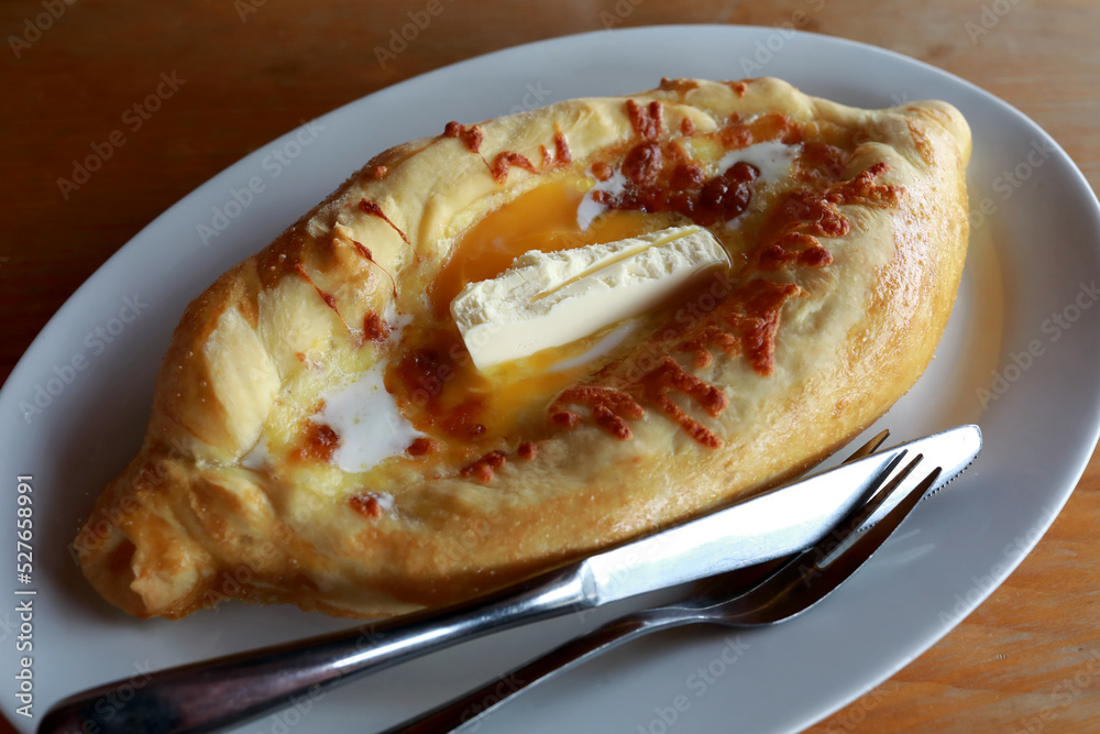 Adjarian khachapuri pie on white plate Adjarian khachapuri pie on white plate