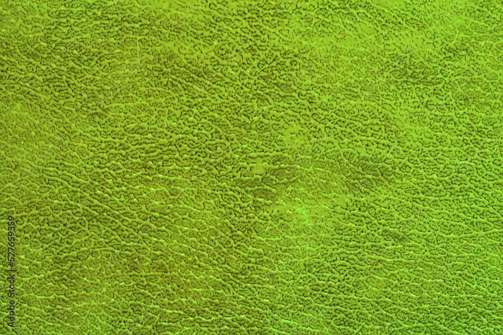 Fototapeta premium Abstract design background of neon green glossy artificial genuine textured creased leather. Flat surface. Skin natural wrinkled scratched wallpaper christmas pattern. Close-up, mock up, top view