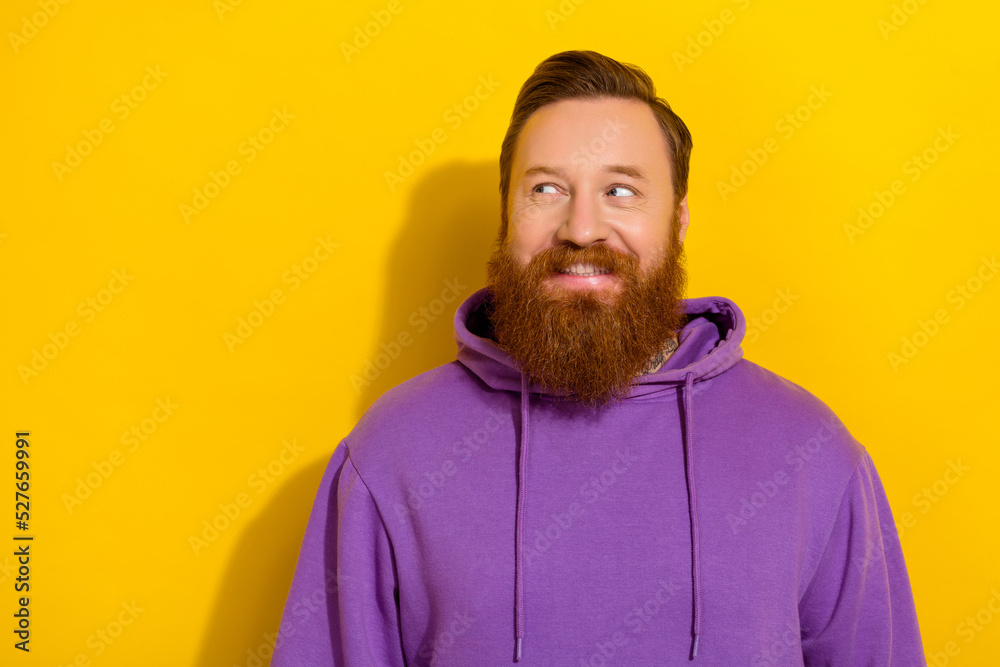Portrait of cheerful handsome male look blank space see promotional advert isolated on yellow color background