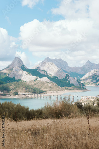 Lake with a brige and the mountains in the background photo