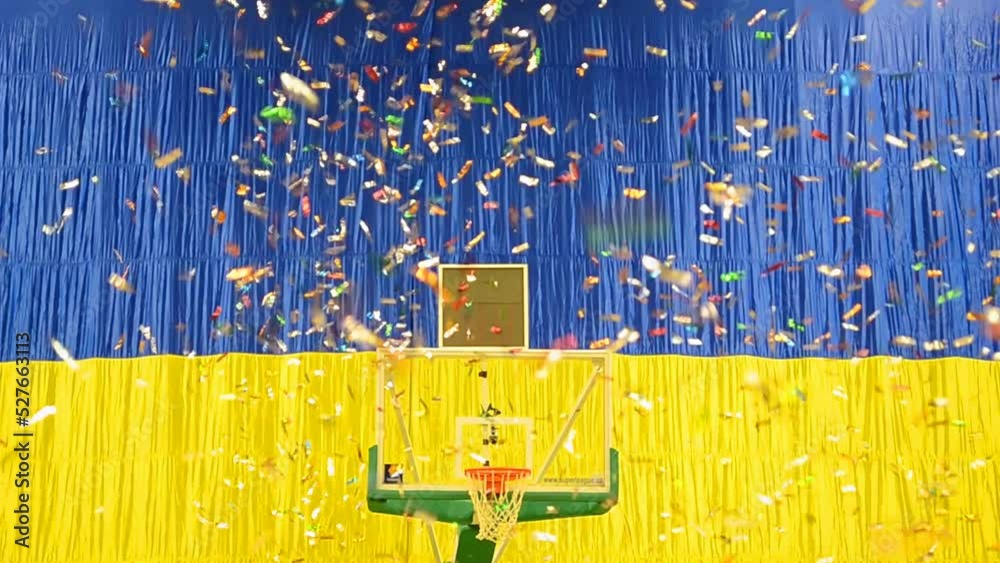 winner ceremony after basketball final on ukrainian flag background, sequins in the air under wind diversity