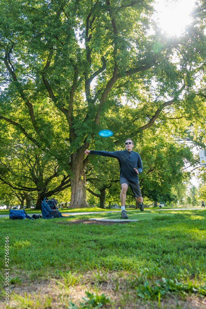Disc golf, a flying disc sport played using rules like golf, being played by a middle aged man on a nine hole course in Ashbridges Bay Park in Toronto’s Beaches neighbourhood in late August. Disc golf, a flying disc sport played using rules like golf, being played by a middle aged man on a nine hole course in Ashbridges Bay Park in Toronto’s Beaches neighbourhood in late August.
