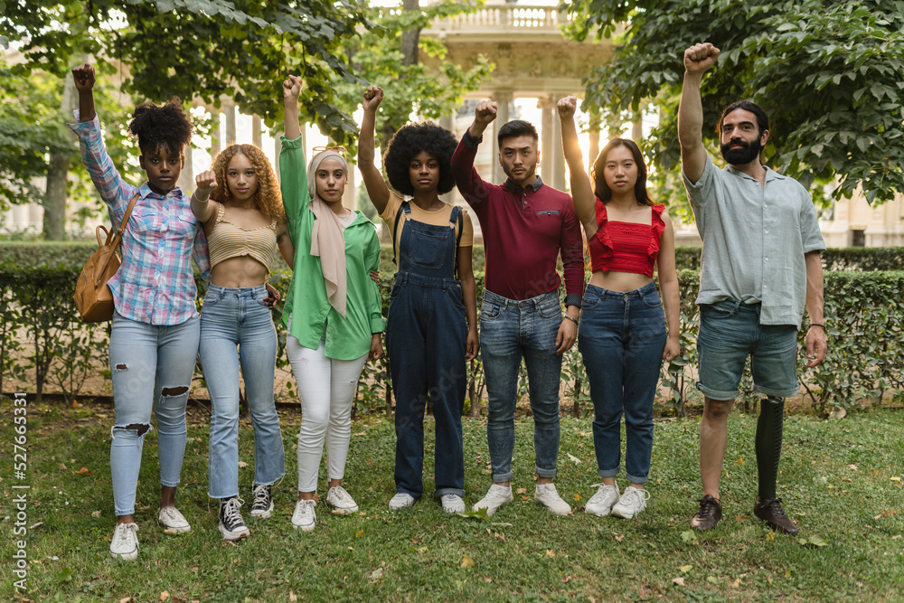 group of multiracial people demonstrating with fist up