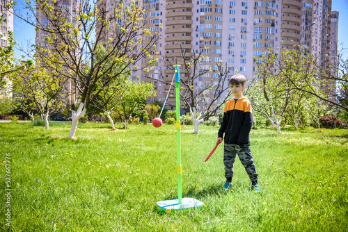 Happy boy is playing tetherball swing ball game in summer campin photo