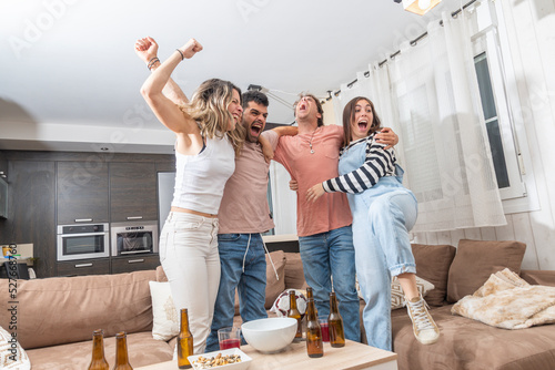Two couples watching a soccer game