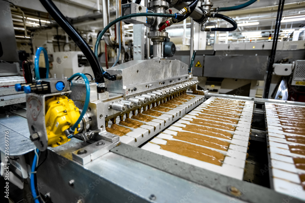 Conveyor belt line of chocolates sweets in food factory