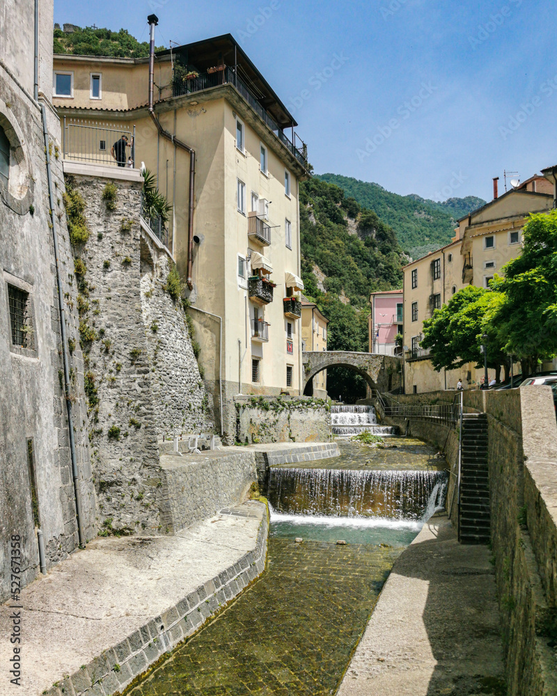 Scenic river with small waterfall crossing the town of Campagna in Salerno province, Campania region, Italy