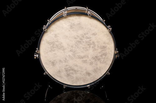 drum head of bass drum on a black background with reflection, for advertising and inscription