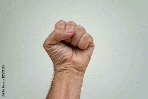 Clenched fist on white background. hand with closed fist. symbol of claw, strength and fight