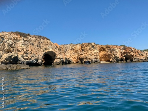 A view of beautiful sandy beach in Armacao de Pera seaside town, Algarve region, Portugal. View from a boat.