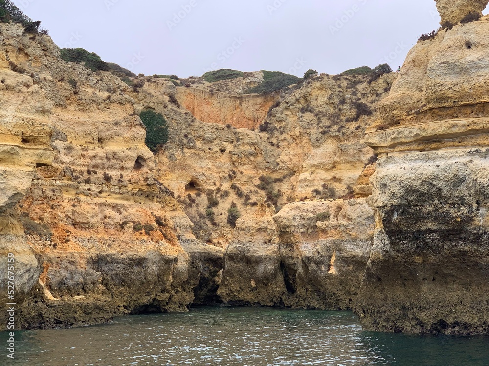 A view of beautiful sandy beach in Armacao de Pera seaside town, Algarve region, Portugal. View from a boat.