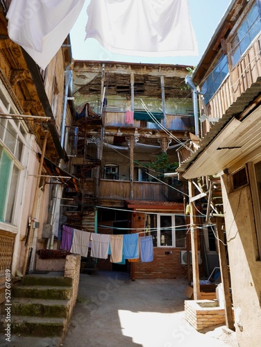 Laundry day in typical courtyard of heritage building in Sololaki district, Tbilisi, Georgia.