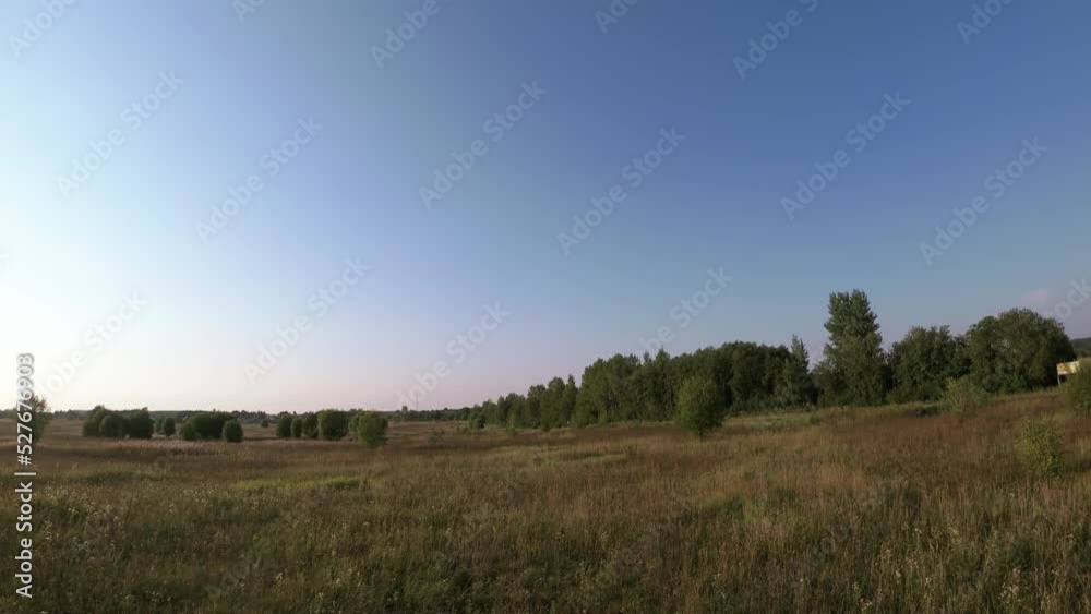 Panoramic FPV flight over wooded meadows at sunset. First person view dynamic aerial landscape Panoramic FPV flight over wooded meadows at sunset. First person view dynamic aerial landscape
