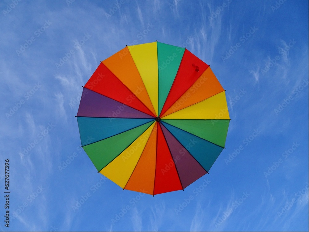 Obraz premium Colored umbrella in the sky. Bottom view.