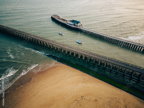 Aerial shot of two sailing boats leaving the harbour in Blankenberge, Belgium photo