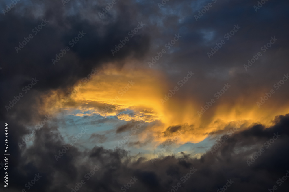 Sunset in dark clouds