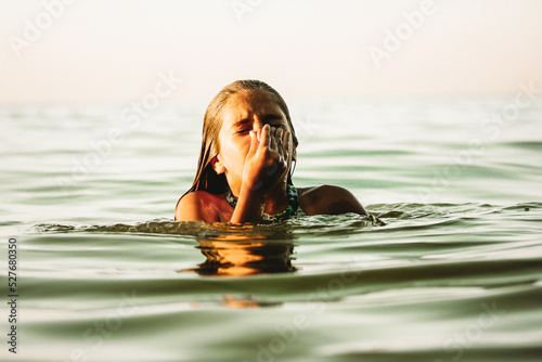 Εκτύπωση καμβά Child drowning in water holding hand above a surface of green water, going deep
