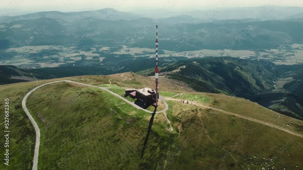 Aerial 4k footage of broadcasting tower on the top of Kralova Hola mountain in Slovakia - Low Tatras. Beautiful and stunning scenic view of mountain with high mountains around.
