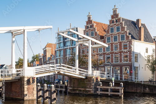 Gravestenenbrug bridge on Spaarne river and old canal houses in Haarlem, Netherlands photo