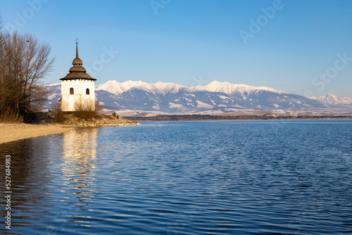 Fototapeta Naklejka Na Ścianę i Meble -  Church of Virgin Mary in Havranok and lake Liptovska Mara, district Liptovsky Mikulas, Slovakia
