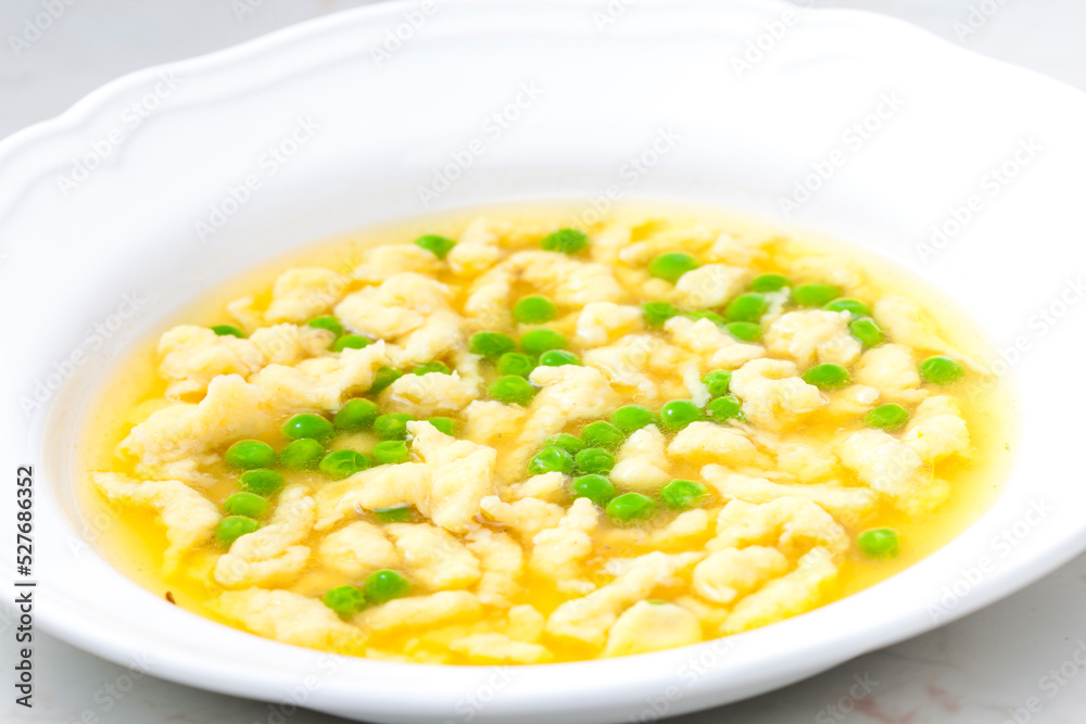 chicken bouillon with homemade dumplings and green peas chicken bouillon with homemade dumplings and green peas