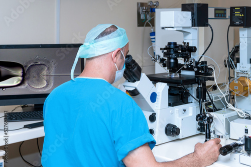 Embryologist adding sperm to egg in laboratory of reproductive clinic. in vitro fertilization, egg freezing. injects one sperm into each egg by microinjection. intracytoplasmic Sperm injection. IMSI