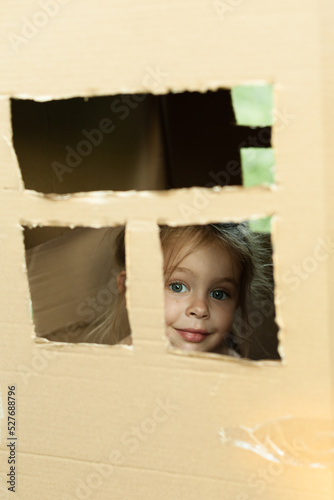 Girl in bundy from a cardboard box photo