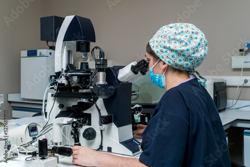 Embryologist adding sperm to egg in laboratory of reproductive clinic. in vitro fertilization, egg freezing. injects one sperm into each egg by microinjection. intracytoplasmic Sperm injection. imsi photo