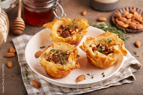 Rose shaped filo pastry cakes with apples, pears, honey  and almond nuts. Delicious autumn homemade dessert.