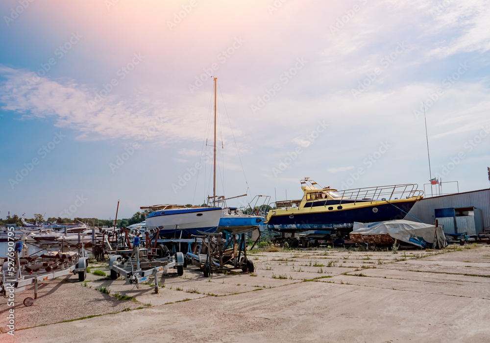 Fototapeta premium Boats and yachts on the shore. Maintenance of ships in the yacht club