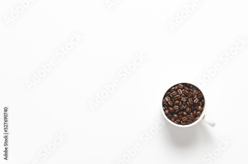 A cup of coffee beans on white background with copy space. 