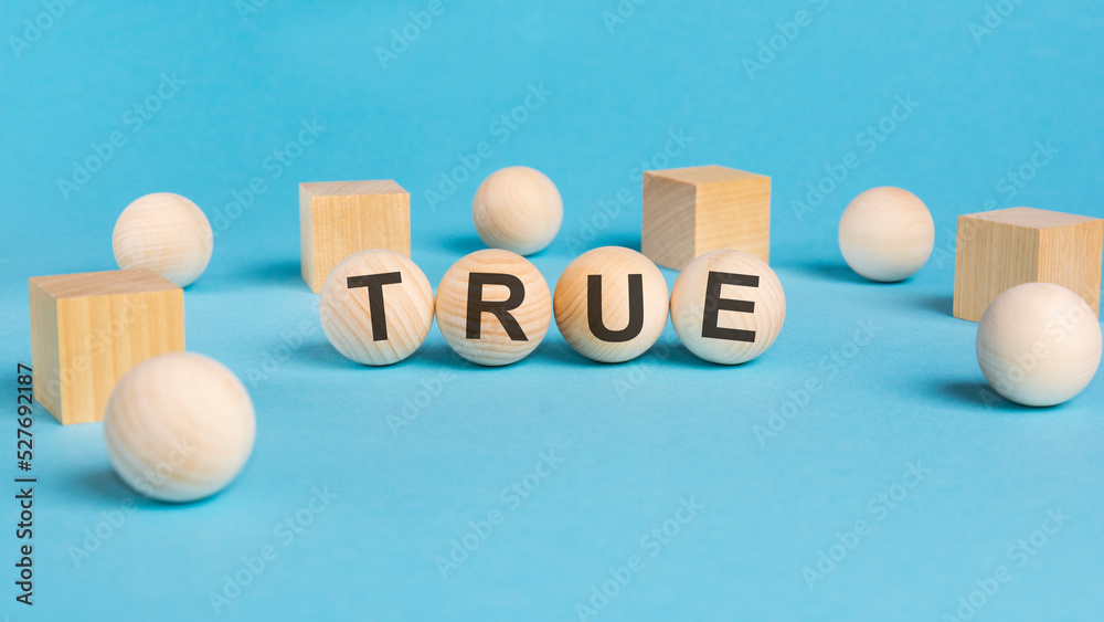 word TRUE, inscription on wooden balls. information concept word TRUE, inscription on wooden balls. information concept