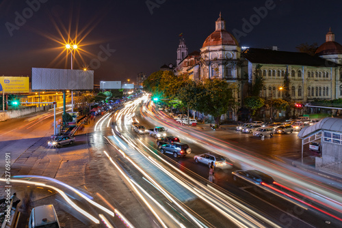 A night shot of cars on a street moving on Strand Rd in center of Yangon, Myanmar, Burma © reisezielinfo