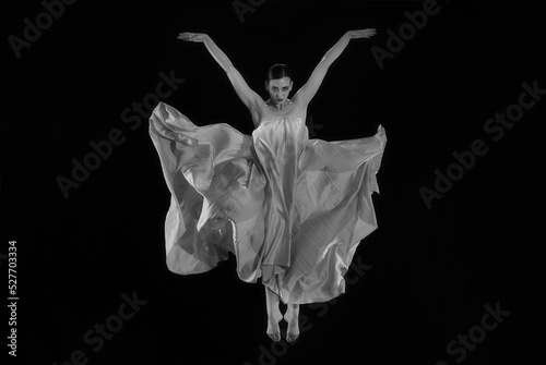 dancer in a jump on a black background, woman falling, woman angel