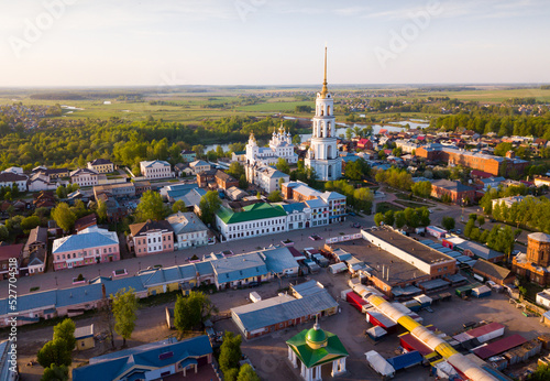 Aerial view of Shuya Orthodox Resurrection cathedral and bell tower on background with Teza River and cityscape, Russia.. photo