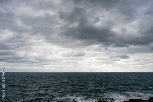 Canvas Print dramatic clouds from the sea before the storm , view from the beach , text stick